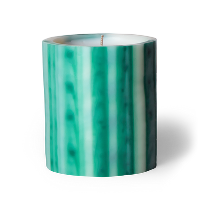 Green and white striped candle on a white background