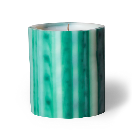 Green and white striped candle on a white background